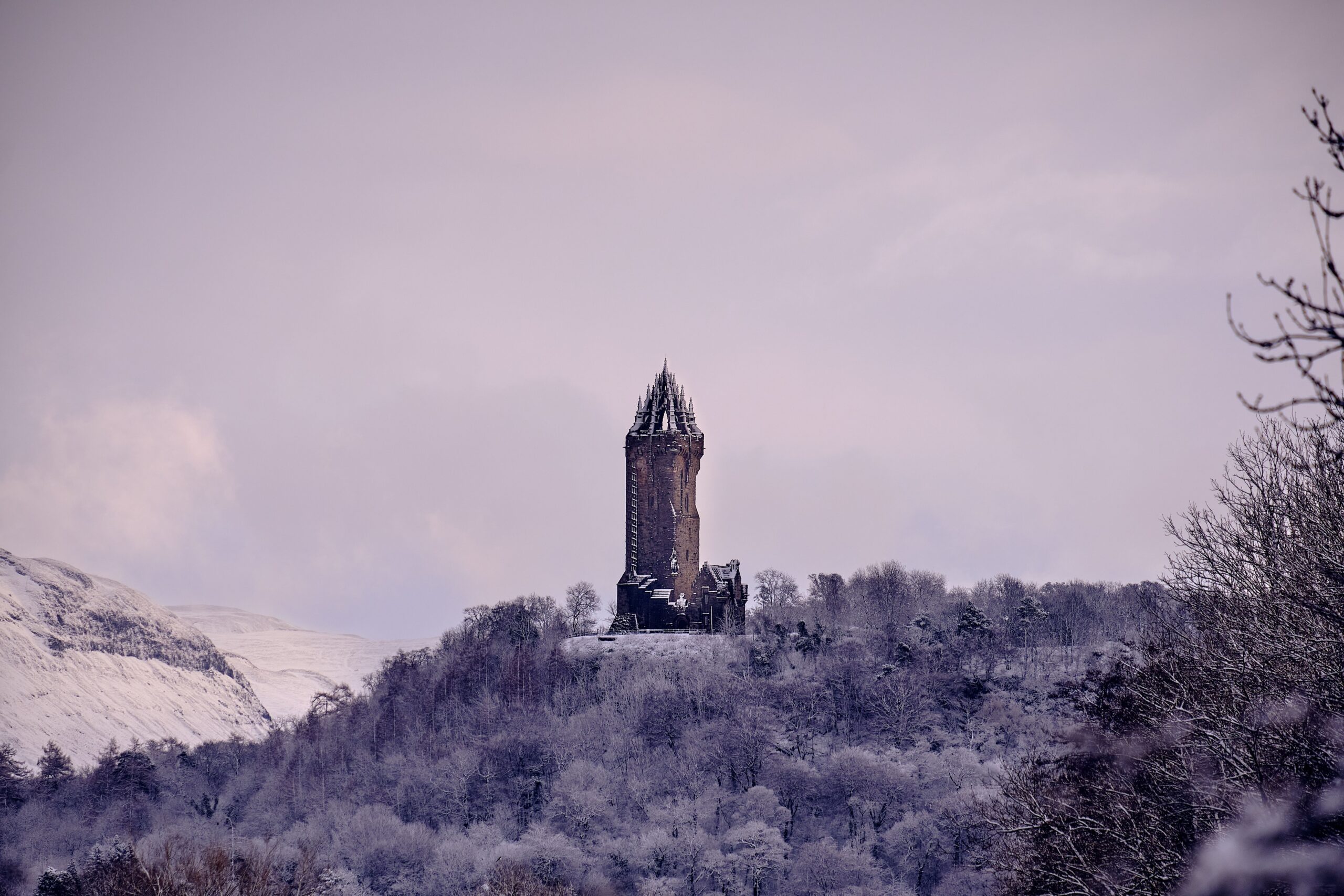 A beautiful view of the Wallace Monument covered with snow in The United Kingdom