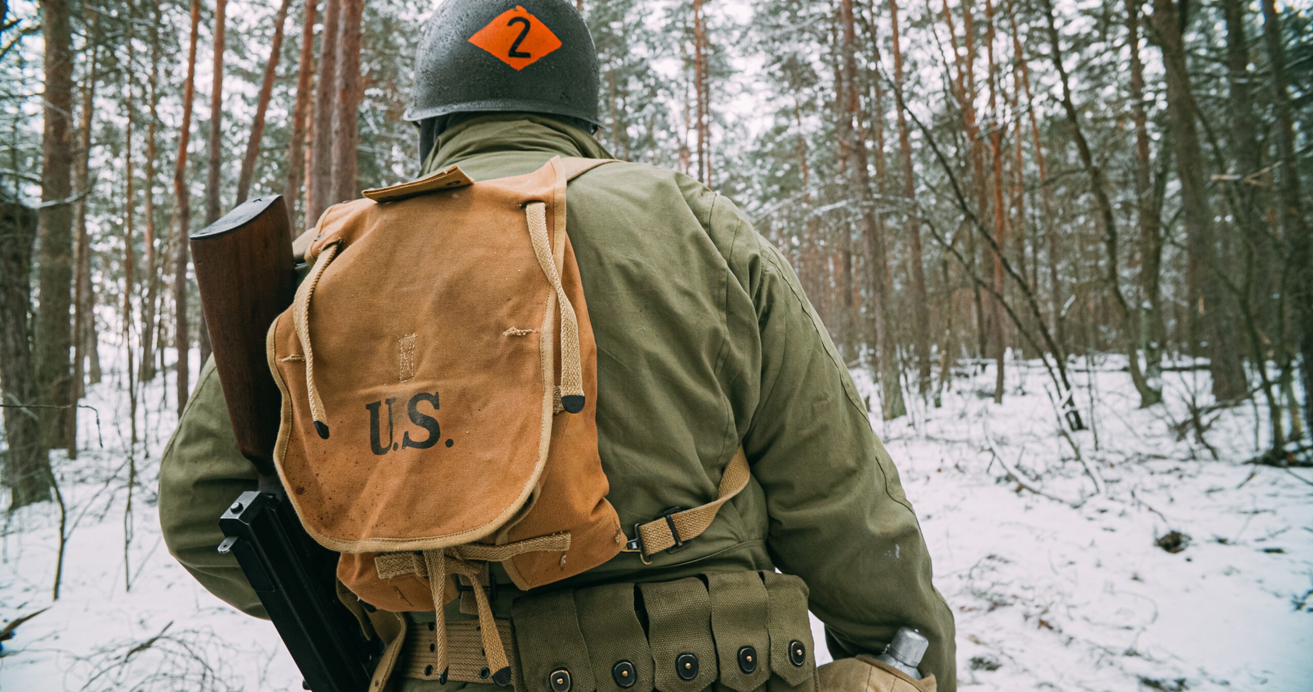American Infantry Soldier Marching Through Forest Road In Cold Winter Day.