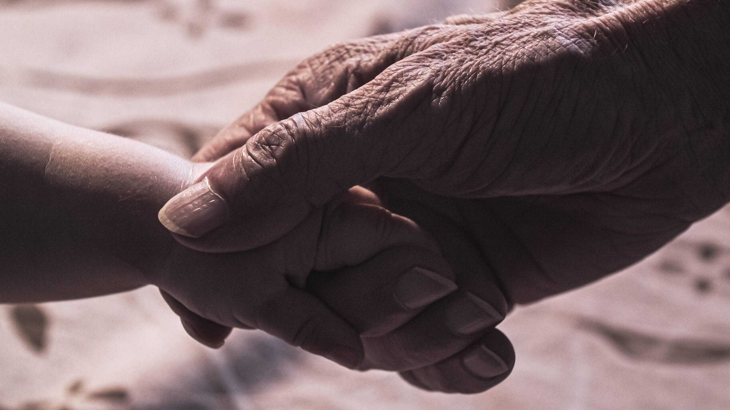 Grandfather holding his grandson's hand.